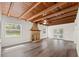 Spacious living room with wood beam ceiling, brick fireplace, and abundant natural light at 7137 Wedgewood Dr, New Port Richey, FL 34652
