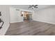 Spacious living room featuring hardwood floors, open concept design, connecting living area and kitchen at 7137 Wedgewood Dr, New Port Richey, FL 34652