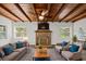 Staged living room highlighting the wood beam ceiling and brick fireplace focal point at 7137 Wedgewood Dr, New Port Richey, FL 34652