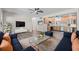 Open concept living area flows into kitchen with hardwood floors and plentiful lighting fixtures at 7137 Wedgewood Dr, New Port Richey, FL 34652
