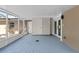Enclosed patio features a blue-painted brick floor, white walls, and entry to the interior at 7137 Wedgewood Dr, New Port Richey, FL 34652