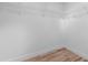 Bright walk-in closet featuring white walls and shelving, complete with modern wood-look flooring at 7137 Wedgewood Dr, New Port Richey, FL 34652