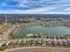Overhead view of a community featuring a pool, clubhouse, and a serene lake at 7380 Sail Clover Ln, Zephyrhills, FL 33540