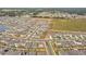 Aerial view of a community with numerous houses, streets, and green spaces at 7380 Sail Clover Ln, Zephyrhills, FL 33540