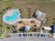Aerial view of community pool and playground area, surrounded by palm trees at 7380 Sail Clover Ln, Zephyrhills, FL 33540