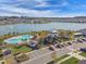 Aerial shot of a community clubhouse with a pool and view of a lake at 7380 Sail Clover Ln, Zephyrhills, FL 33540