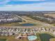 Aerial view showcasing the community pool, clubhouse, and surrounding neighborhood at 7380 Sail Clover Ln, Zephyrhills, FL 33540