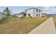 Spacious backyard featuring a white fence, playset, and a garden bed; a perfect outdoor living space at 7380 Sail Clover Ln, Zephyrhills, FL 33540