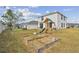 Lush backyard featuring a playset and a garden bed, perfect for outdoor activities and gardening at 7380 Sail Clover Ln, Zephyrhills, FL 33540