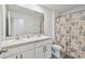 Bright bathroom features a double sink vanity, neutral shower curtain and modern fixtures at 7380 Sail Clover Ln, Zephyrhills, FL 33540