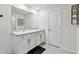 Bright bathroom featuring a double vanity, modern lighting, and stylish fixtures at 7380 Sail Clover Ln, Zephyrhills, FL 33540