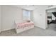 Bright bedroom with a white daybed, cute bedding, and ample natural light at 7380 Sail Clover Ln, Zephyrhills, FL 33540