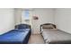 Shared ' bedroom showcasing twin beds with cozy bedding and a window view at 7380 Sail Clover Ln, Zephyrhills, FL 33540