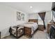 Cozy bedroom with wooden bed frame, decorative wall art, and convenient bedside table at 7380 Sail Clover Ln, Zephyrhills, FL 33540