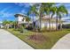 Exterior view of the community clubhouse with lush landscaping and bright blue skies at 7380 Sail Clover Ln, Zephyrhills, FL 33540