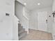 Welcoming foyer with tiled flooring, staircase, and a bright, inviting entrance at 7380 Sail Clover Ln, Zephyrhills, FL 33540