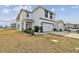 A two-story home boasts a two-car garage and charming front porch at 7380 Sail Clover Ln, Zephyrhills, FL 33540