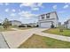 View of a two-story modern home with a two-car garage and a long driveway at 7380 Sail Clover Ln, Zephyrhills, FL 33540