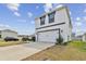 Exterior view of a modern two-story home with a white facade and a two-car garage at 7380 Sail Clover Ln, Zephyrhills, FL 33540