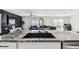 Kitchen sink with island and living area in the background at 7380 Sail Clover Ln, Zephyrhills, FL 33540