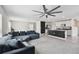Open-concept living space flowing into a modern kitchen with a stylish island at 7380 Sail Clover Ln, Zephyrhills, FL 33540