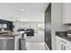 Open concept living area with modern kitchen island and a comfortable sectional sofa at 7380 Sail Clover Ln, Zephyrhills, FL 33540