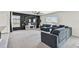 Cozy living area features a stylish accent wall and modern entertainment center at 7380 Sail Clover Ln, Zephyrhills, FL 33540