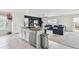 Open concept living area showcases modern kitchen island and a comfortable sectional sofa at 7380 Sail Clover Ln, Zephyrhills, FL 33540