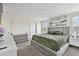 Spacious main bedroom featuring a king bed, dresser, and ample natural light at 7380 Sail Clover Ln, Zephyrhills, FL 33540