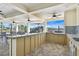 Outdoor kitchen area with granite countertops and stainless steel appliances near the pool at 7380 Sail Clover Ln, Zephyrhills, FL 33540