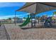Community playground area with slide and climbing structure, covered for shade and protection from sun at 7380 Sail Clover Ln, Zephyrhills, FL 33540
