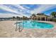 Inviting community pool with clear blue water and a clubhouse in the background on a bright day at 7380 Sail Clover Ln, Zephyrhills, FL 33540