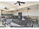 Outdoor dining area with ceiling fans and a kitchen featuring a sink and countertop, perfect for entertaining at 7380 Sail Clover Ln, Zephyrhills, FL 33540