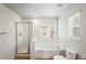 Clean bathroom with a glass-enclosed shower and a soaking tub by the window at 7412 Bridgeview Dr, Wesley Chapel, FL 33545