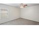 Cozy bedroom featuring a ceiling fan, a window, and a carpeted floor at 7412 Bridgeview Dr, Wesley Chapel, FL 33545
