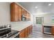 Kitchen featuring stainless steel appliances, wood cabinets, and a view of the dining area at 7412 Bridgeview Dr, Wesley Chapel, FL 33545