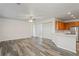 Expansive open-concept room with wood flooring, kitchen, and fan at 7412 Bridgeview Dr, Wesley Chapel, FL 33545