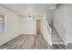 Open-concept living room with wood floors and staircase with carpet runner at 7412 Bridgeview Dr, Wesley Chapel, FL 33545