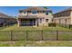 Backyard with patio and black metal fence at 7852 Stoney Hill Dr, Wesley Chapel, FL 33545