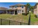 Backyard with patio and black metal fence at 7852 Stoney Hill Dr, Wesley Chapel, FL 33545