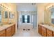Elegant bathroom featuring dual vanities, a soaking tub, and a separate shower at 7852 Stoney Hill Dr, Wesley Chapel, FL 33545