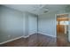 This bedroom features laminate wood floors, a ceiling fan, and a double door closet at 7852 Stoney Hill Dr, Wesley Chapel, FL 33545