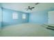 Large, light-filled bedroom with plush carpeting and a ceiling fan for added comfort at 7852 Stoney Hill Dr, Wesley Chapel, FL 33545