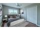 This bedroom features a ceiling fan, a window, a closet, and hard wood floors at 7852 Stoney Hill Dr, Wesley Chapel, FL 33545