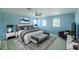 Serene bedroom with a large window, stylish furniture, and a cozy rug at 7852 Stoney Hill Dr, Wesley Chapel, FL 33545