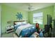 Bright bedroom featuring a blue nautical themed décor and a window view to the exterior lake at 7852 Stoney Hill Dr, Wesley Chapel, FL 33545