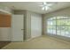 This bedroom features carpet flooring, a ceiling fan, a closet, and a window at 7852 Stoney Hill Dr, Wesley Chapel, FL 33545