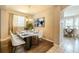 Elegant dining room offers a marble table, modern decor, hardwood floors, and plenty of natural light at 7852 Stoney Hill Dr, Wesley Chapel, FL 33545