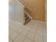 Entryway features tile flooring, a staircase with carpeted steps, and white trim, perfect for greeting guests at 7852 Stoney Hill Dr, Wesley Chapel, FL 33545