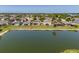 Back of home featuring a spacious screened-in patio overlooking a serene lake and manicured backyard at 7852 Stoney Hill Dr, Wesley Chapel, FL 33545